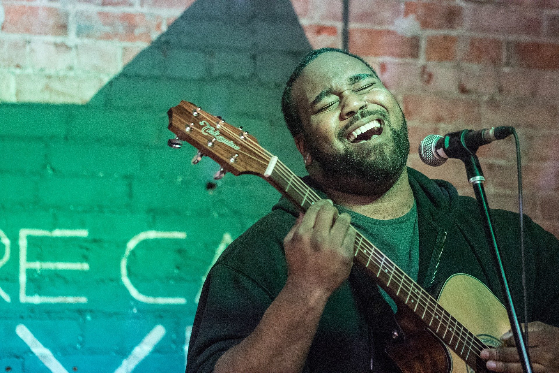 A guy playing his guitar.