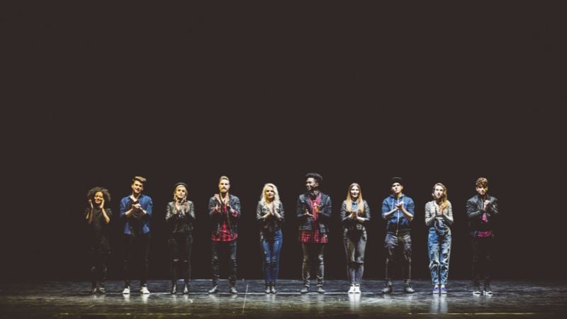 A group of high schoolers on stage.