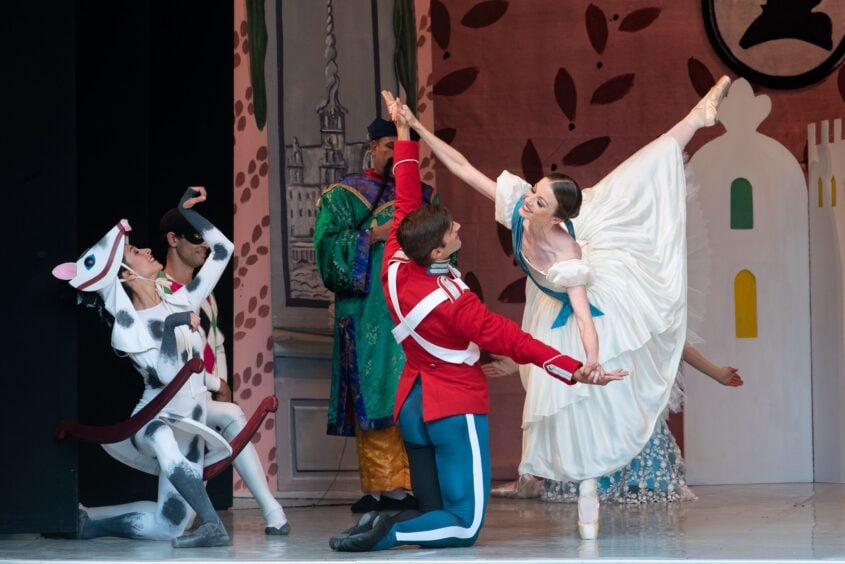Three ballet dancers on the stage.