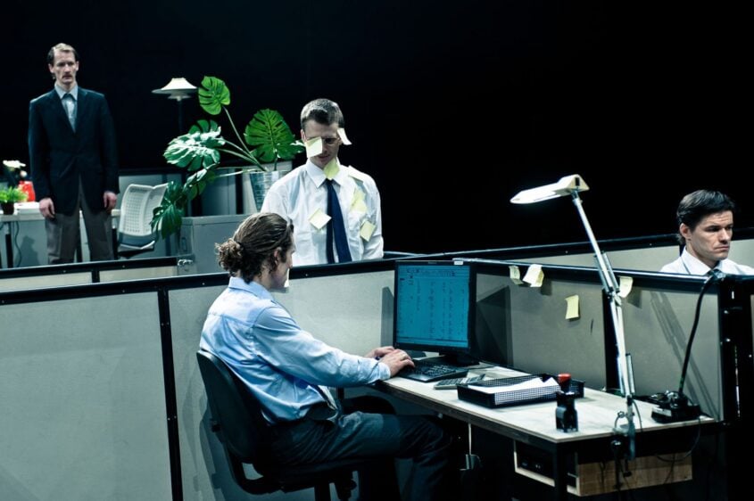 Men in their cubicles. Production still from BLAM! the Show.