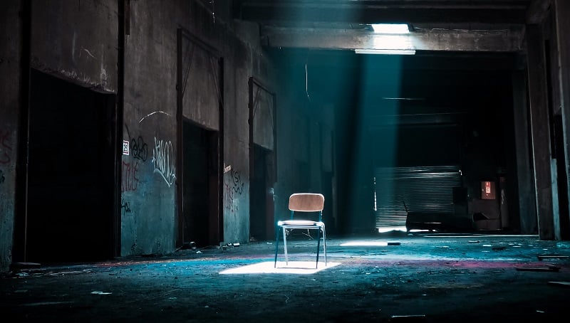 A chair on a dark stage.