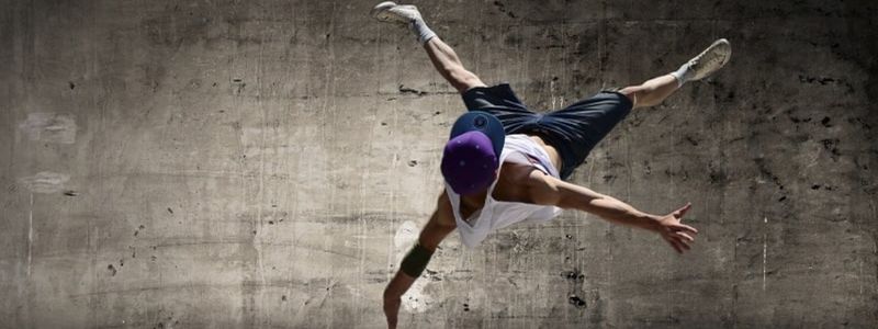 A young break dancer doing a flip.