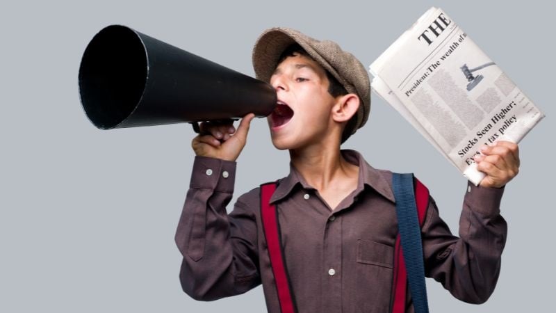 A boy with a newspaper and a megaphone.
