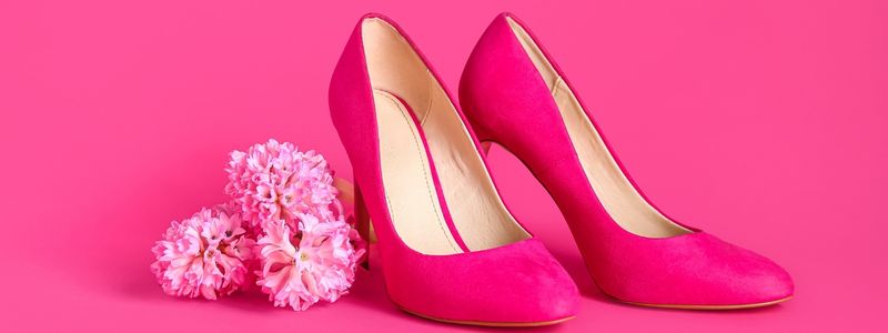 Hot pink heels on a hot pink background.