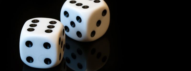 Two dice with a black background.