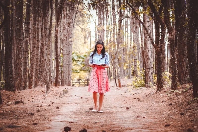 A woman reading in the forest.