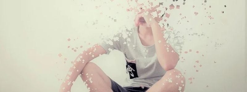 A boy fading away into pixels.