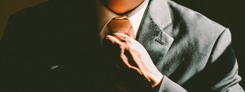 A man fixing his tie.