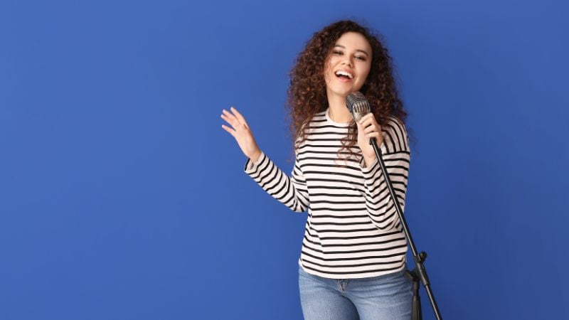 A woman singing into a microphone.