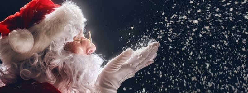 Santa blowing magical snow into the air.