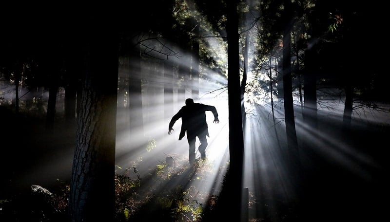 Frankenstein running through the forest.