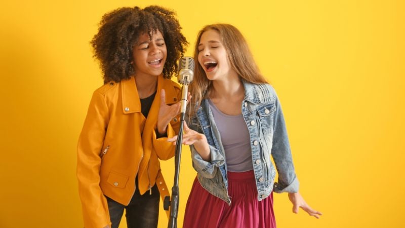 Two kids singing together.