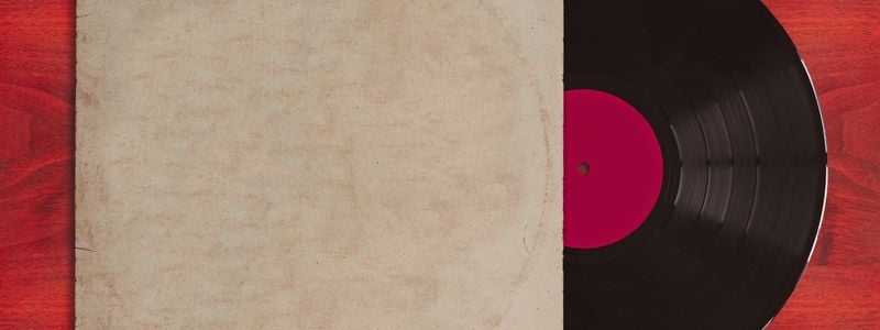 A red record on a red wooden background.