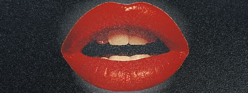 Big red lips on a black background.