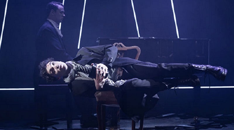 Keith Ramsay lying near a piano in Preludes.
