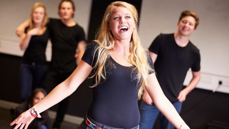 Teens doing acting exercises.