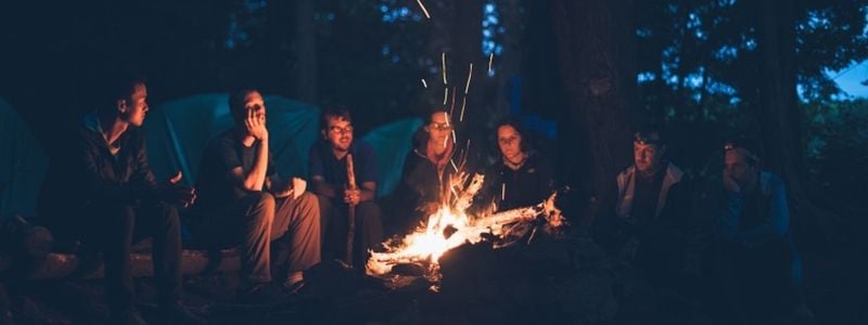 Young campers around a fire.