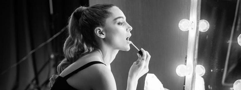 A woman getting ready backstage.