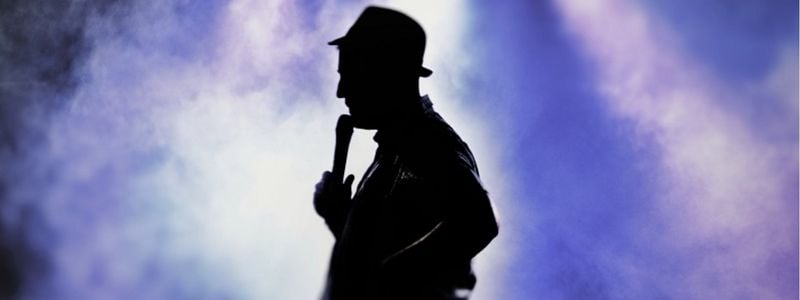 A silhouette of someone at the microphone.