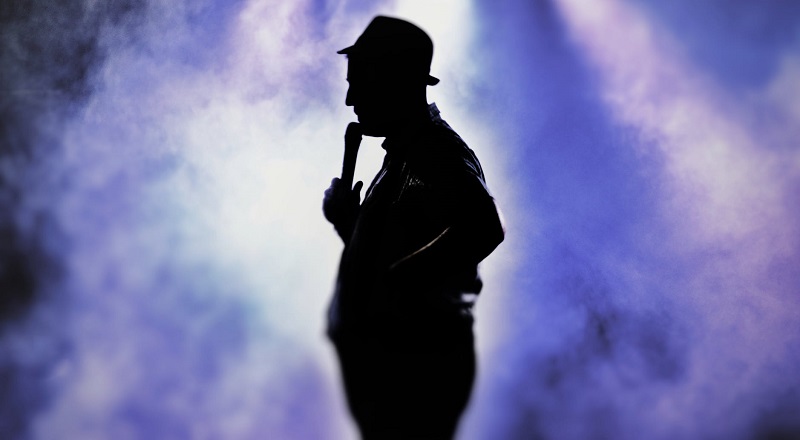 A silhouette of someone at the microphone.