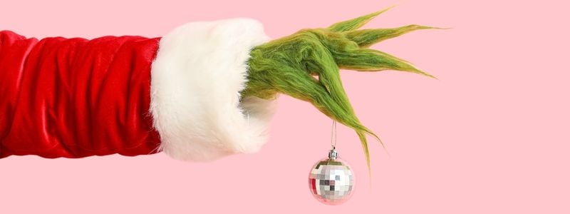 The Grinch's hand holding an ornament.