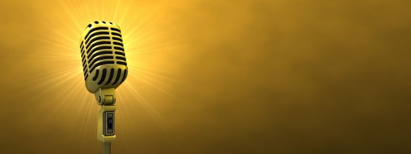 A glowing microphone with yellow background.