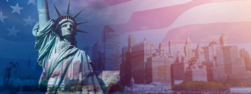 The Statue of Liberty with a flag background.