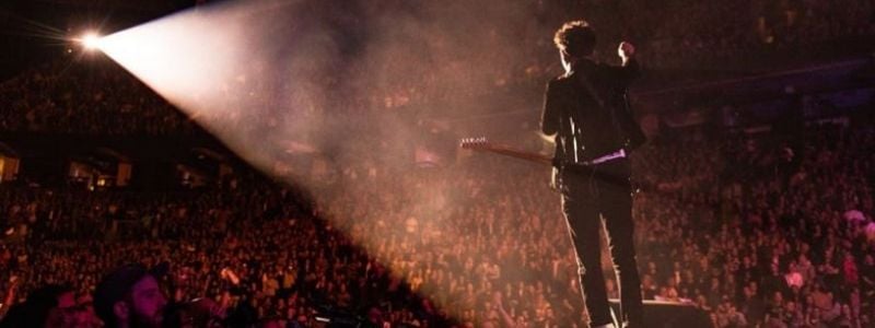 A guitarist performing on stage.