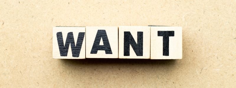 "WANT" written out with block tiles.