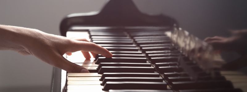 A hand playing the piano.