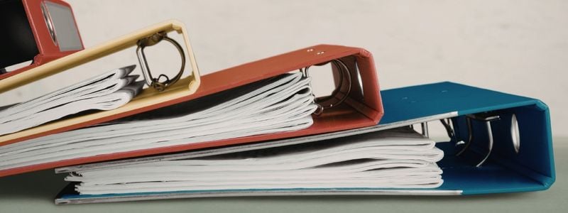 Four full binders, stacked on one another