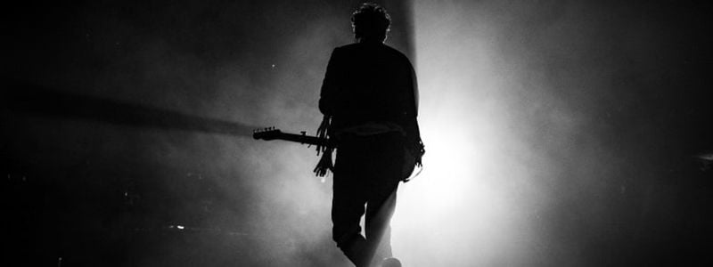 A guitarist walking on stage.