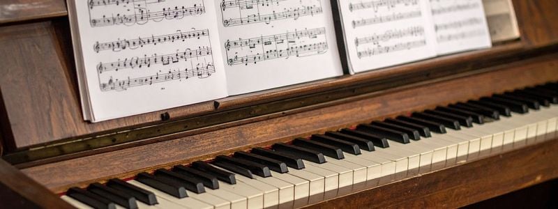 A vintage piano with sheet music.