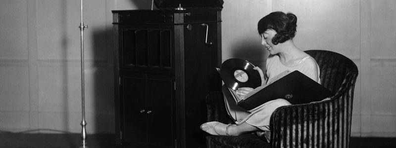 A 1930s woman holding a record in her hands.