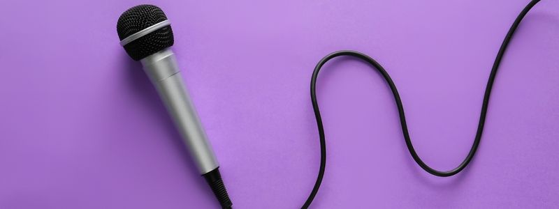 A microphone on a purple background.