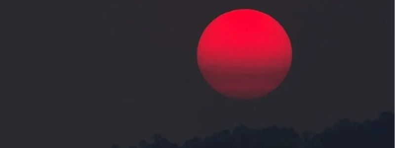 A red moon in the night sky.