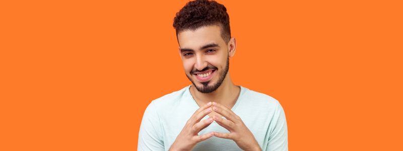 A man looking vengeful with an orange background.