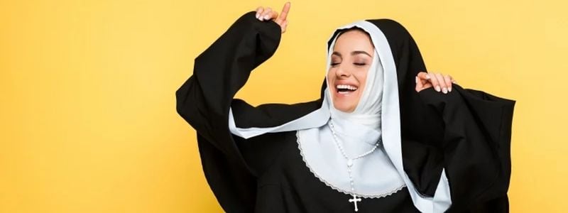 A happy nun with a yellow background.
