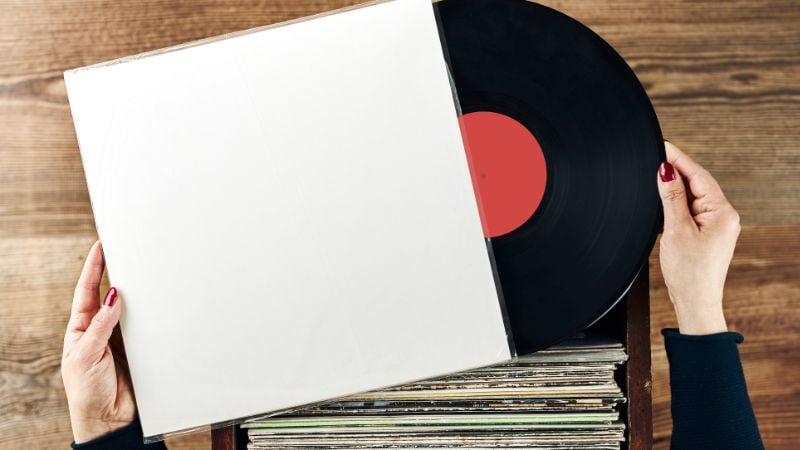 Hands holding a music record.