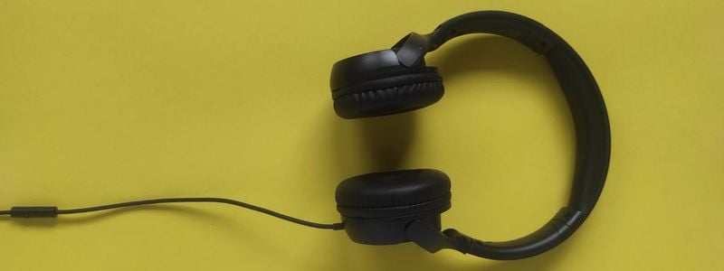 Big headphones on a yellow background.