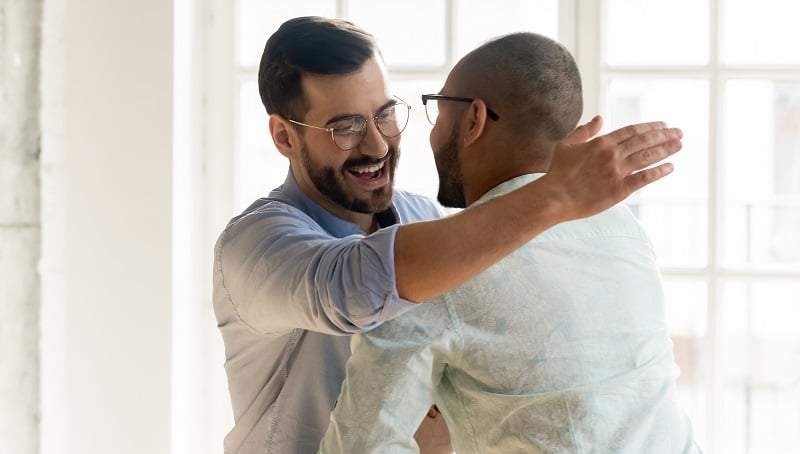 Two male friends embracing.