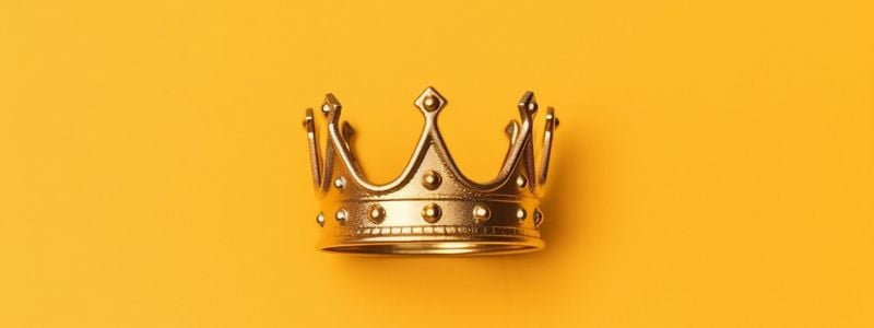 A gold crown on a yellow background.
