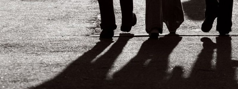 The shadow of three friends walking.