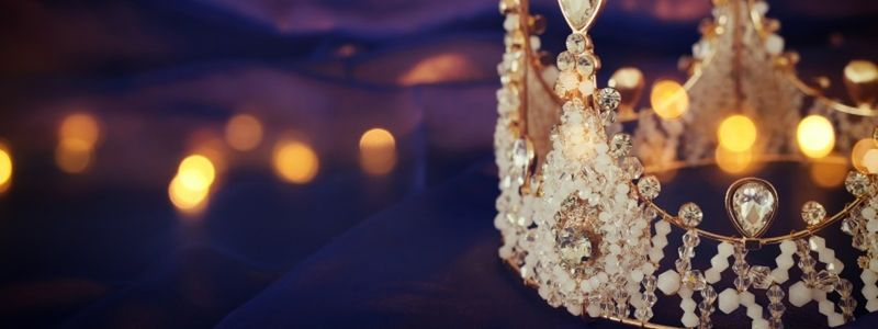 A royal gold crown with a purple background.