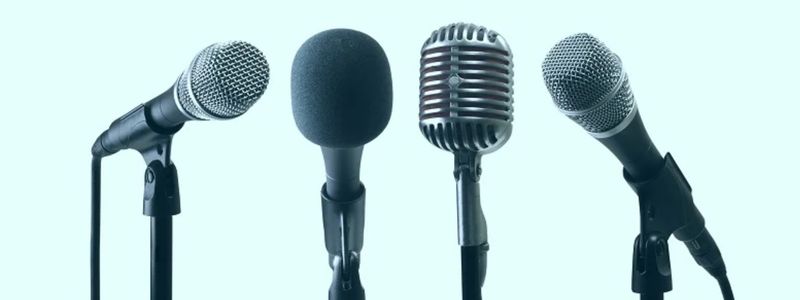Four microphones with a light blue background.