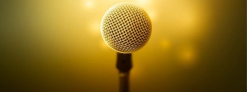 A microphone with golden yellow background.