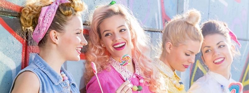 Four 1950s style women with lollipops.