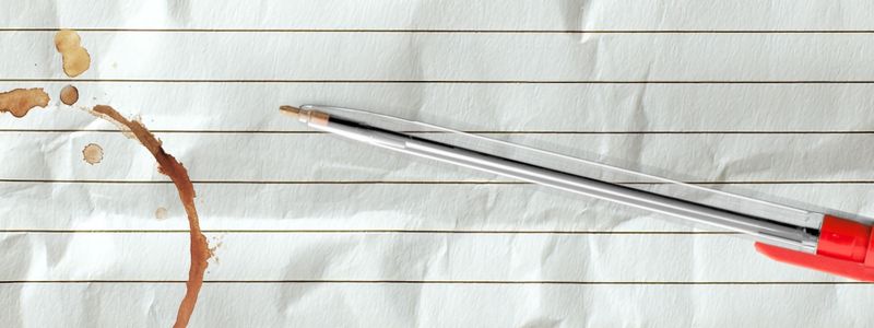 Crumpled lined paper with a pen on top.