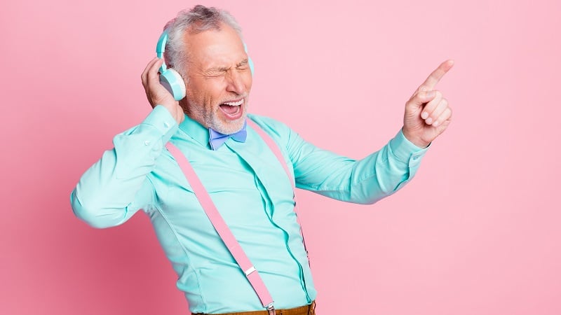 An older man singing.