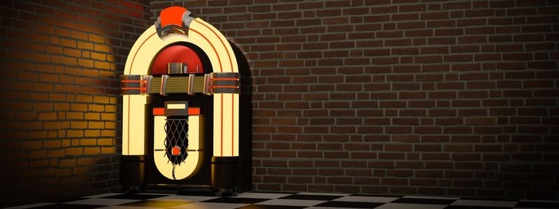 A lit up jukebox in a corner.
